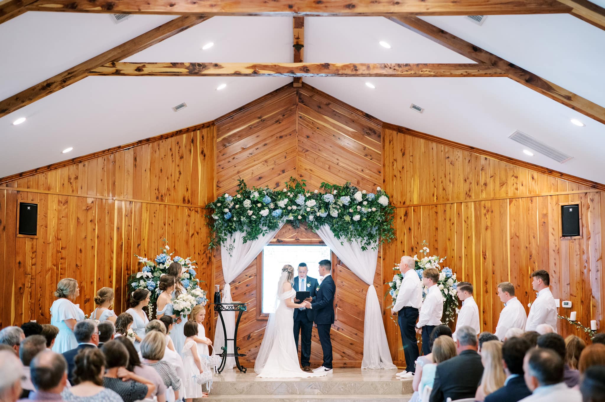 A couple getting married in front of an audience.